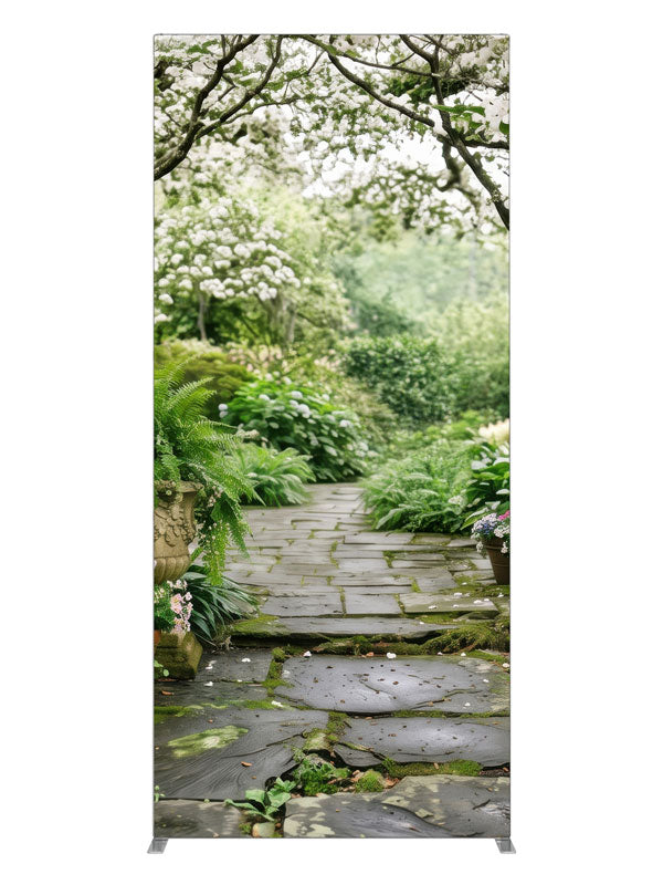 A stone garden path beneath blooming white dogwood trees with ferns, hostas and potted roses, 3ft photography backdrop panel for Denny StudioEdge silicone edge frame