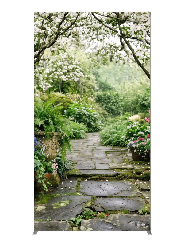 A stone garden path beneath blooming white dogwood trees with ferns, hostas and potted roses, 4ft photography backdrop panel for Denny StudioEdge silicone edge frame