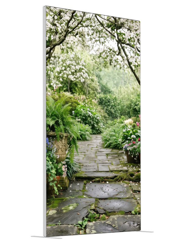 A stone garden path beneath blooming white dogwood trees with ferns, hostas and potted roses, 4ft photography backdrop panel for Denny StudioEdge silicone edge frame, angled view