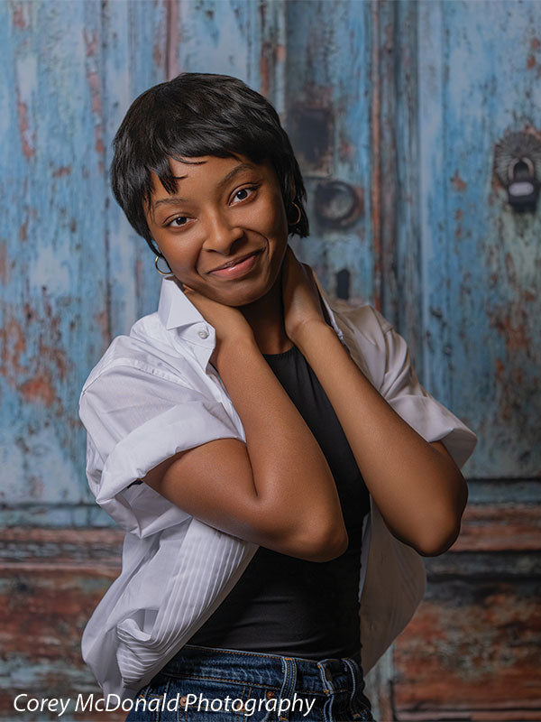Blue Desire Street, photography backdrop panel for Denny StudioEdge silicone edge frame, shown with a senior girl in a white shirt over a black top with a hand at the back of her neck SECP-7654
