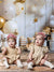 Twin girls wearing birthday crowns seated in front of gold star balloons and teddy bears on the Bears and Stars Cake Smash Backdrop.