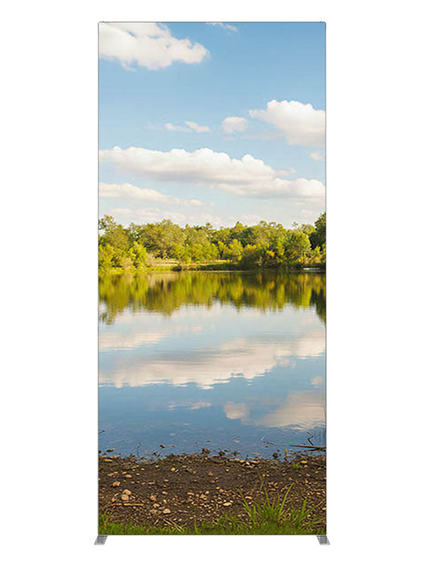 A calm lake mirroring a blue cloud-filled sky with a green tree line and grassy banks, 3ft photography backdrop panel for Denny StudioEdge silicone edge frame