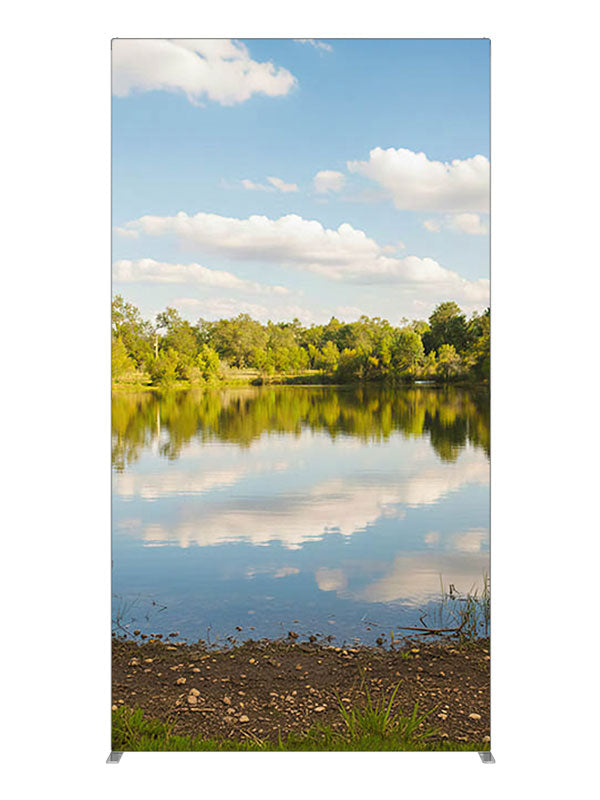 A calm lake mirroring a blue cloud-filled sky with a green tree line and grassy banks, 4ft photography backdrop panel for Denny StudioEdge silicone edge frame