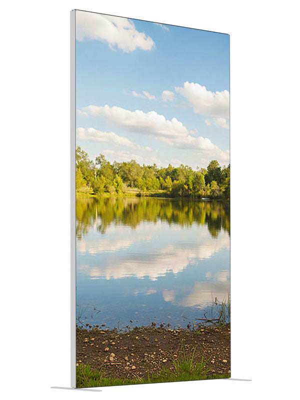 A calm lake mirroring a blue cloud-filled sky with a green tree line and grassy banks, 4ft photography backdrop panel for Denny StudioEdge silicone edge frame