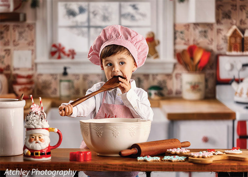 Candy Kitchen retro gingerbread kitchen photography backdrop shown with a young boy in a pink chef apron tasting from a spoon while baking CP-8911
