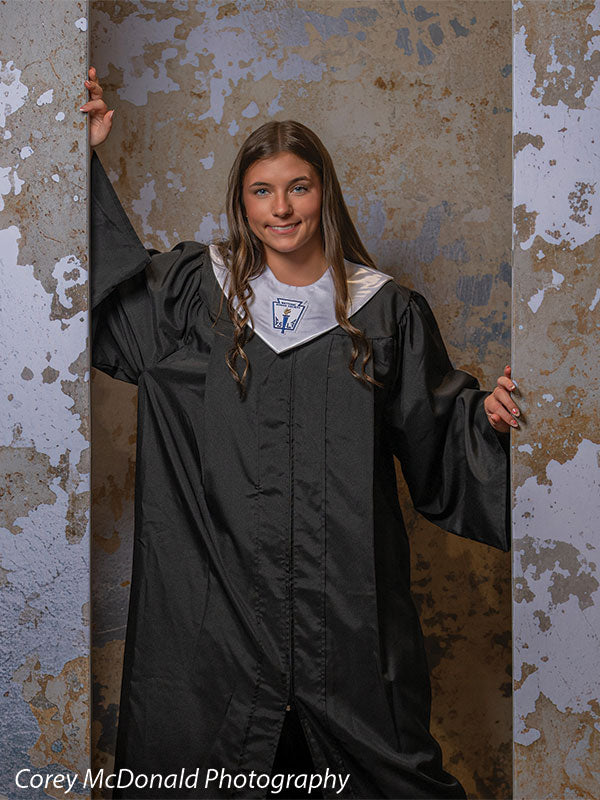 Caspian Silver and Beige Weathered Texture, photography backdrop panel for Denny StudioEdge silicone edge frame, shown with a senior girl in a black graduation gown with arms raised, full-length SECP-8856