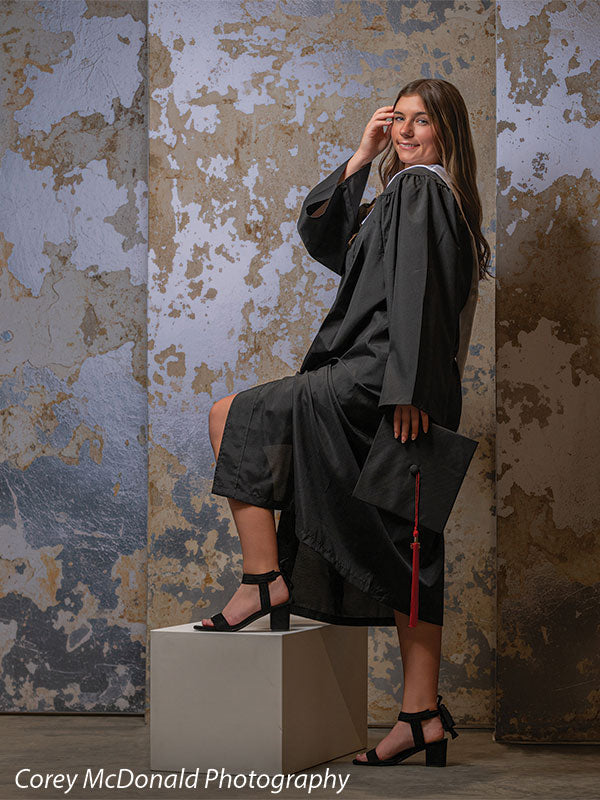 Caspian Silver and Beige Weathered Texture, photography backdrop panel for Denny StudioEdge silicone edge frame, shown with a senior girl in a graduation gown with a foot on a white posing cube holding her cap SECP-8856