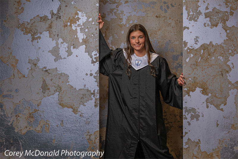 Caspian Silver and Beige Weathered Texture, photography backdrop panel for Denny StudioEdge silicone edge frame, shown with a senior girl in a black graduation gown with one arm raised SECP-8856