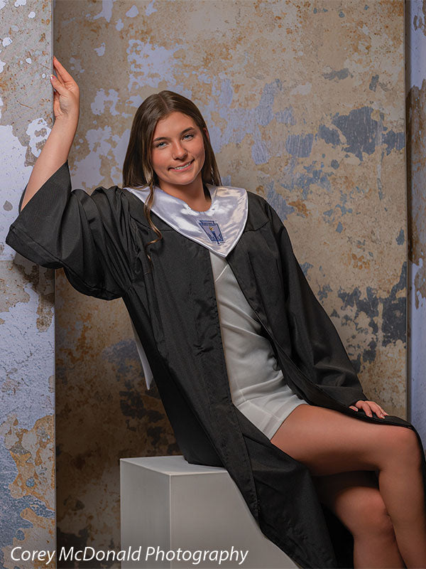 Caspian Silver and Beige Weathered Texture, photography backdrop panel for Denny StudioEdge silicone edge frame, shown with a senior girl in a graduation gown seated on a white posing cube with an arm raised, smiling SECP-8856