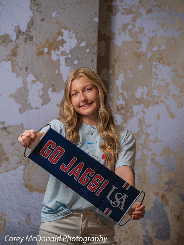 Caspian Silver and Beige Weathered Texture, photography backdrop panel for Denny StudioEdge silicone edge frame, shown with a senior girl holding a Go Jags banner SECP-8856