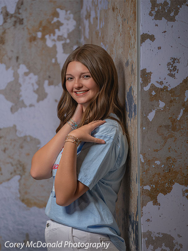 Caspian Silver and Beige Weathered Texture, photography backdrop panel for Denny StudioEdge silicone edge frame, shown with a senior girl smiling with a hand on her shoulder SECP-8856