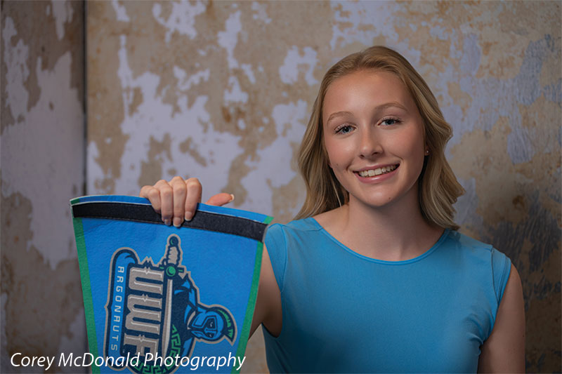 Caspian Silver and Beige Weathered Texture, photography backdrop panel for Denny StudioEdge silicone edge frame, shown with a senior girl in a blue top holding a school pennant SECP-8856