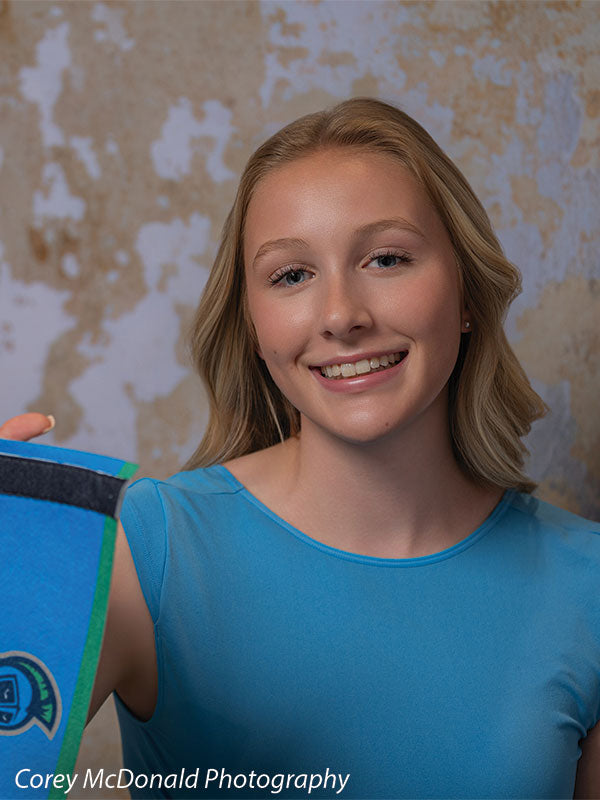 Caspian Silver and Beige Weathered Texture, photography backdrop panel for Denny StudioEdge silicone edge frame, shown with a smiling senior girl in a blue top holding a school pennant SECP-8856