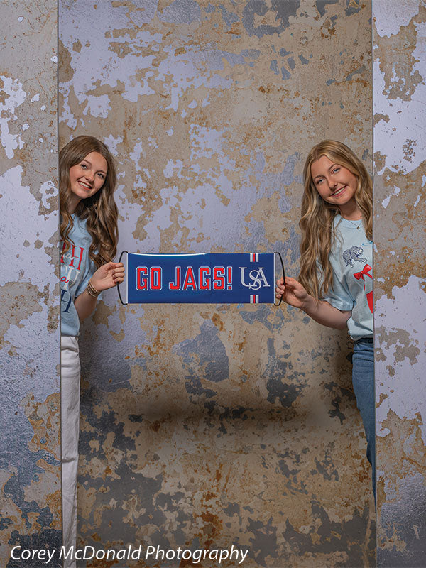 Caspian Silver and Beige Weathered Texture, photography backdrop panel for Denny StudioEdge silicone edge frame, shown with two senior girls holding a Go Jags banner SECP-8856