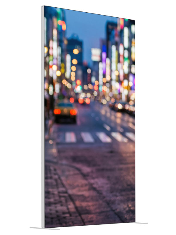 A city street at dusk blurred into multicolored out-of-focus light orbs over a reflective road, 4ft photography backdrop panel for Denny StudioEdge silicone edge frame, angled view