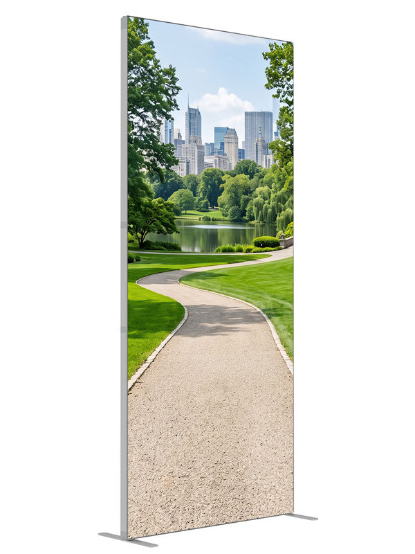 A landscaped city park with a winding gravel path, lake and flower borders below a distant skyline, 3ft photography backdrop panel for Denny StudioEdge silicone edge frame, angled view