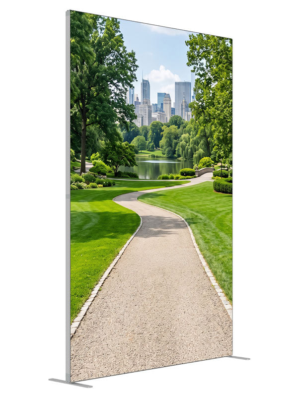 A landscaped city park with a winding gravel path, lake and flower borders below a distant skyline, 5ft photography backdrop panel for Denny StudioEdge silicone edge frame, angled view