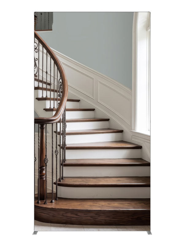 A light curved staircase with iron scroll balusters, white wainscot and a tall arched window, 4ft photography backdrop panel for Denny StudioEdge silicone edge frame