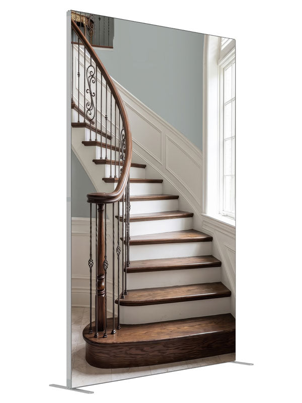 A light curved staircase with iron scroll balusters, white wainscot and a tall arched window, 5ft photography backdrop panel for Denny StudioEdge silicone edge frame, angled view