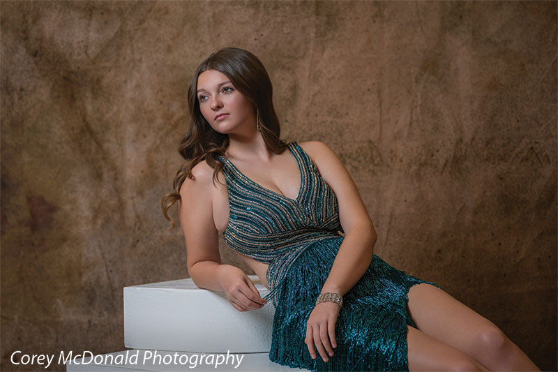 Corner Steps posing prop shown with a senior girl in a teal fringe gown reclining against the white foam corner steps Cor-Step