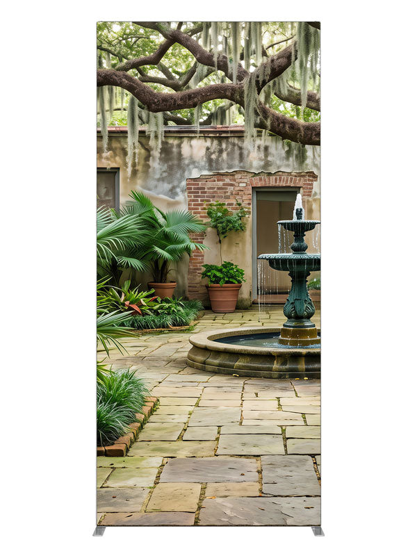 An enclosed courtyard with a tiered fountain, potted palms and aged walls under a moss-draped oak, 3ft photography backdrop panel for Denny StudioEdge silicone edge frame