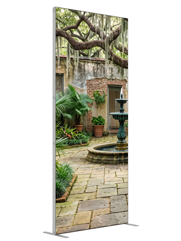 An enclosed courtyard with a tiered fountain, potted palms and aged walls under a moss-draped oak, 3ft photography backdrop panel for Denny StudioEdge silicone edge frame, angled view
