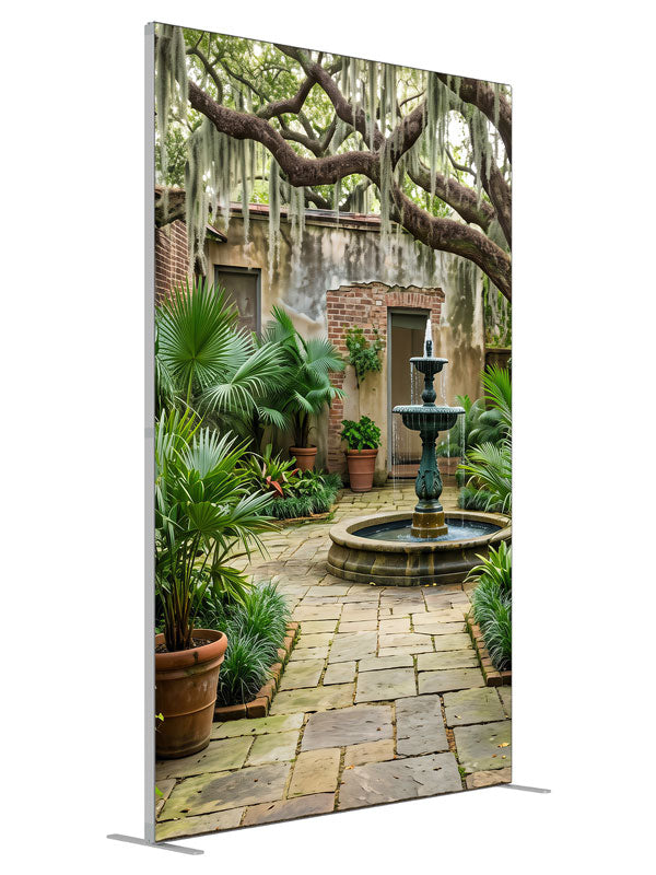 An enclosed courtyard with a tiered fountain, potted palms and aged walls under a moss-draped oak, 5ft photography backdrop panel for Denny StudioEdge silicone edge frame, angled view