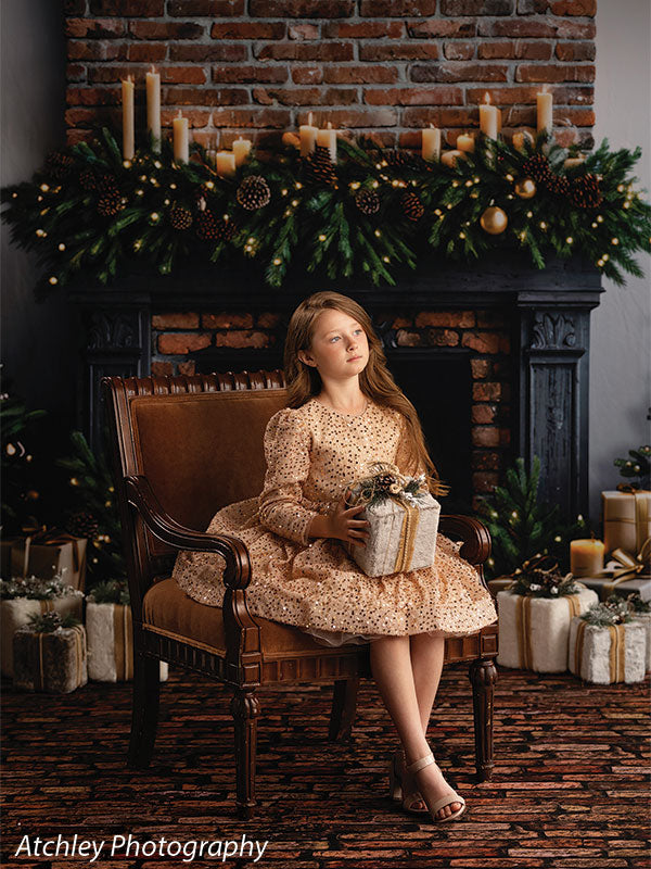 Dark old brick photography floor drop shown with a girl in a gold sequin dress seated by a brick fireplace on the dark old brick floor FD-4082