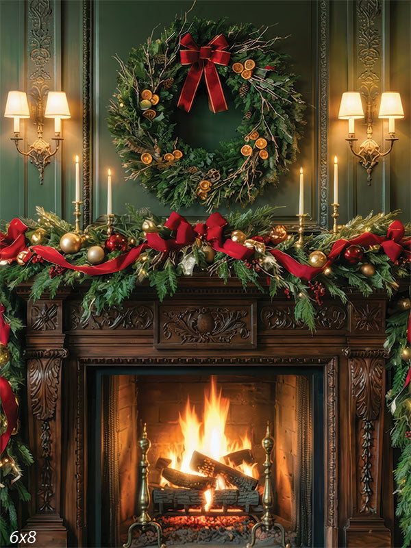 A festive interior scene showing a wooden fireplace with a burning fire, decorated with garland, red bows, and ornaments, with a large green wreath hanging above on a dark green paneled wall, surrounded by built-in bookshelves filled with books and framed portraits, and lit by wall sconces and candles.