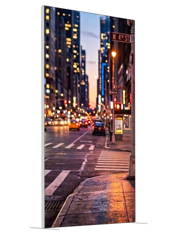 A wet downtown street corner at dusk with a signal post, crosswalk and neon-lit buildings, 4ft photography backdrop panel for Denny StudioEdge silicone edge frame, angled view