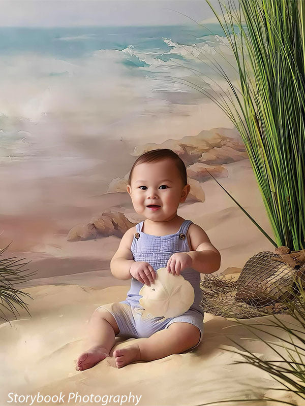Baby sitting on sand in front of lighthouse beach backdrop, holding a shell, perfect for natural newborn and family portraits.