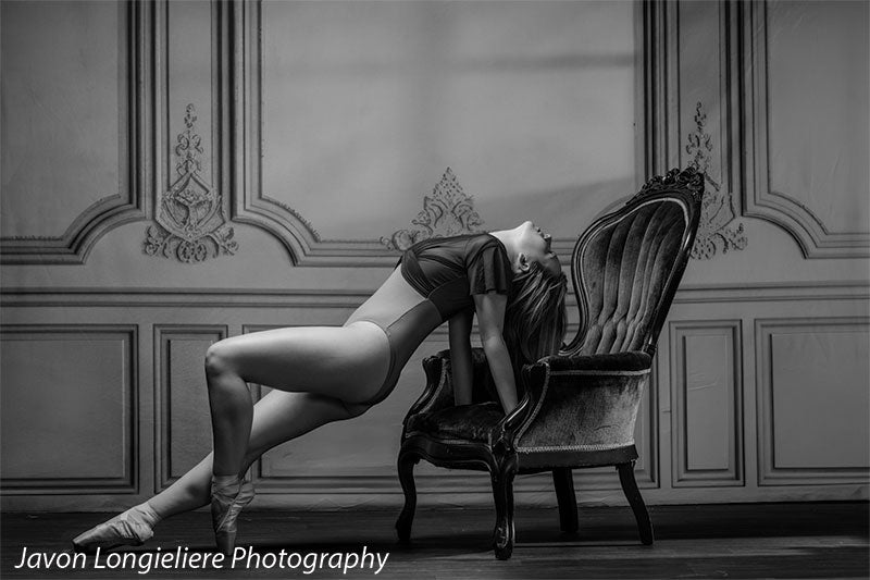 Elegant French Panel Wall photography backdrop with an antique green velvet armchair, shown with a young ballet dancer arching back against the chair en pointe in a black and white portrait CP-8744