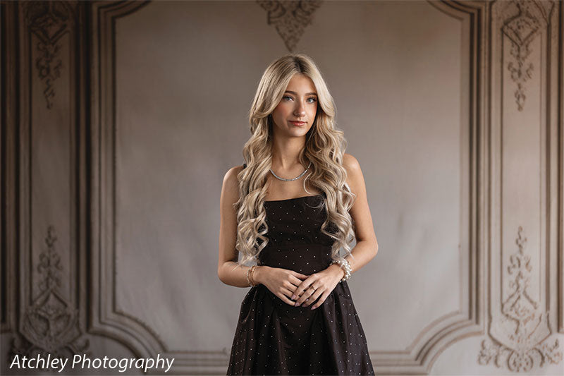 Elegant French panel wall photography backdrop shown with a senior girl in a black dress standing by the French panel wall, wide view CP-8744