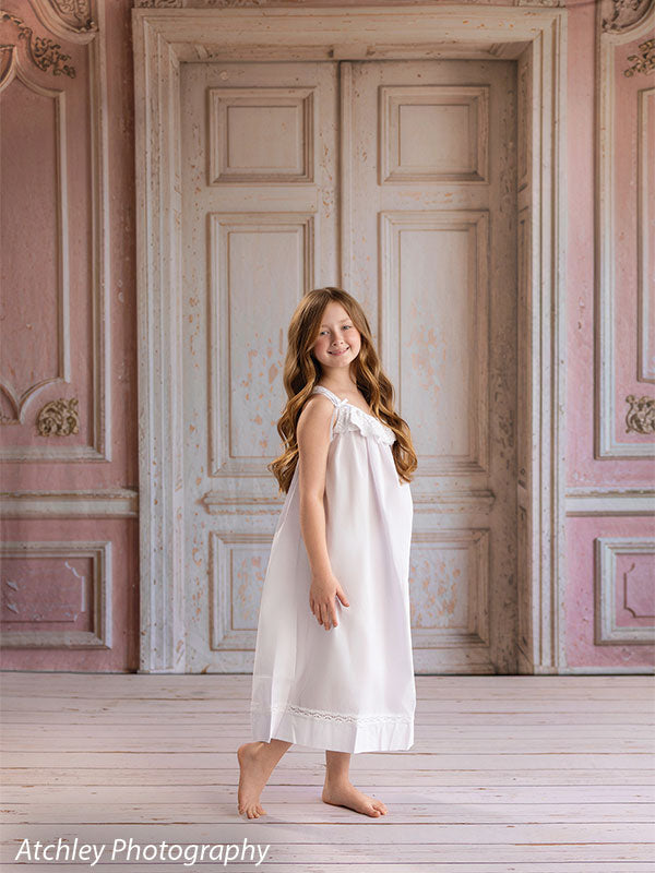 Farmhouse whitewash wood photography floor drop shown with a young girl in a white nightgown looking down, on the whitewash wood floor FD-4270