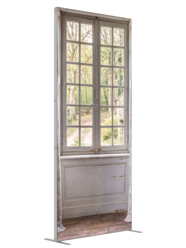 A pale blue-gray French country room with a window onto a spring garden and stone cottage, 3ft photography backdrop panel for Denny StudioEdge silicone edge frame, angled view