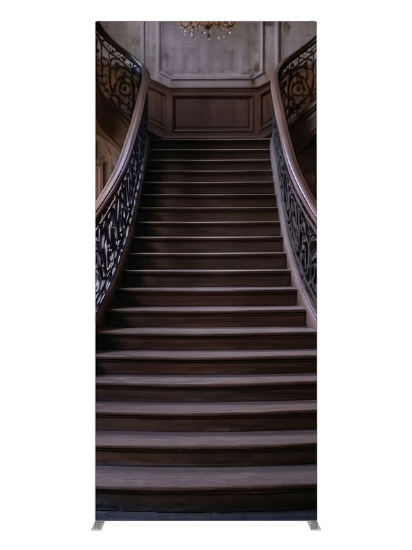 An opulent mansion foyer staircase with iron scroll railings and lit crystal chandeliers, 3ft photography backdrop panel for Denny StudioEdge silicone edge frame