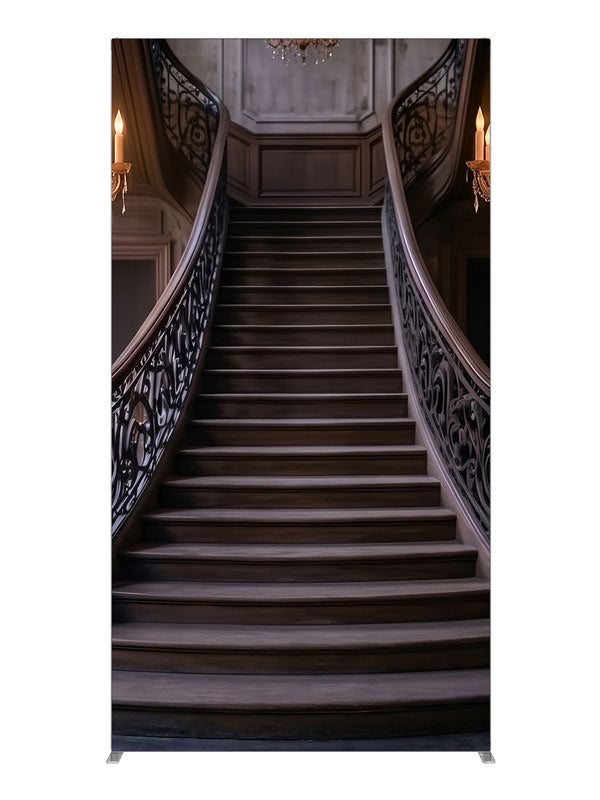 An opulent mansion foyer staircase with iron scroll railings and lit crystal chandeliers, 4ft photography backdrop panel for Denny StudioEdge silicone edge frame
