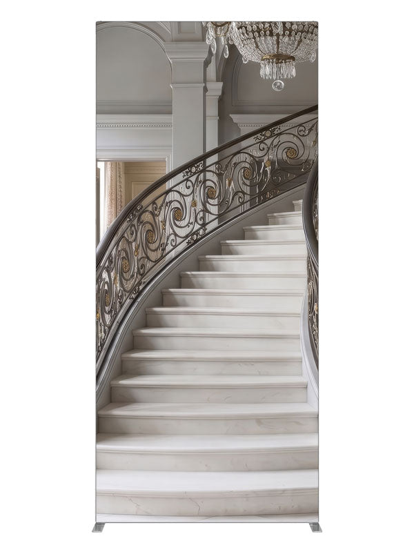 A grand curved gray marble staircase with bronze-and-gold iron railings and a crystal chandelier, 3ft photography backdrop panel for Denny StudioEdge silicone edge frame