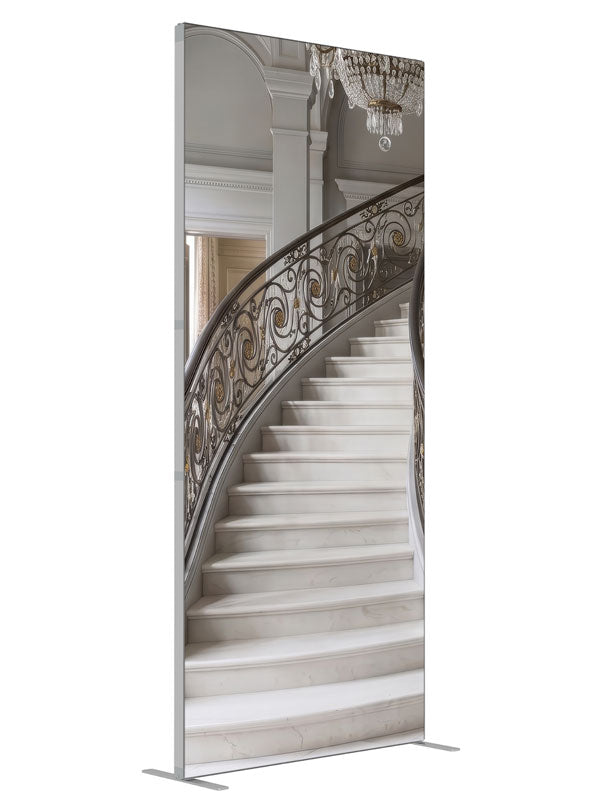 A grand curved gray marble staircase with bronze-and-gold iron railings and a crystal chandelier, 3ft photography backdrop panel for Denny StudioEdge silicone edge frame, angled view