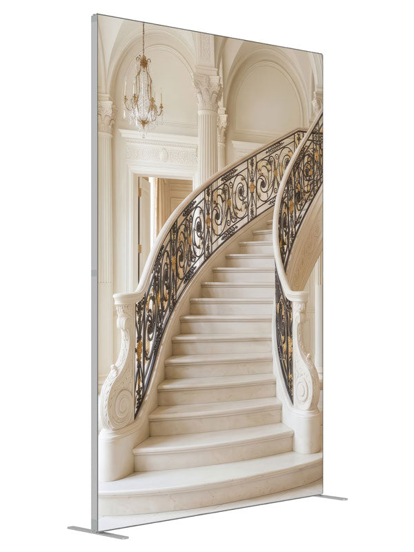 A palatial ivory marble curved staircase with black-and-gold iron railings in a vaulted neoclassical hall, 5ft photography backdrop panel for Denny StudioEdge silicone edge frame, angled view