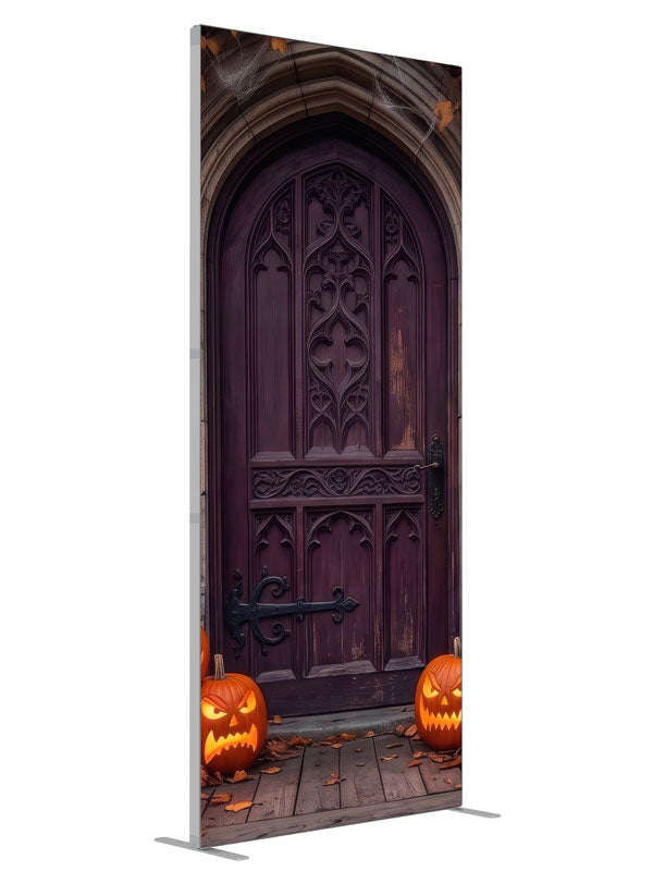 Cobwebbed Gothic arched door in weathered stone with glowing jack-o'-lanterns at the base, 3ft photography backdrop panel for Denny StudioEdge silicone edge frame, angled view