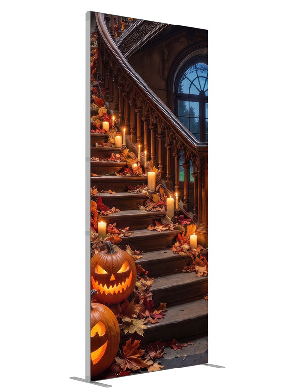 Ornate curved manor staircase dressed with glowing jack-o'-lanterns, candles, and autumn leaves, 3ft photography backdrop panel for Denny StudioEdge silicone edge frame, angled view
