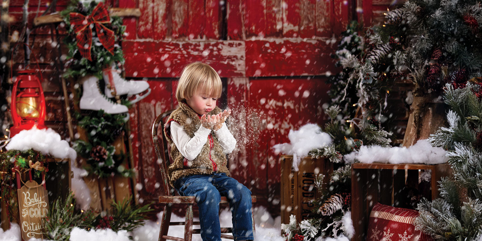 Child sitting in snowy Red Bard Door Backdrop