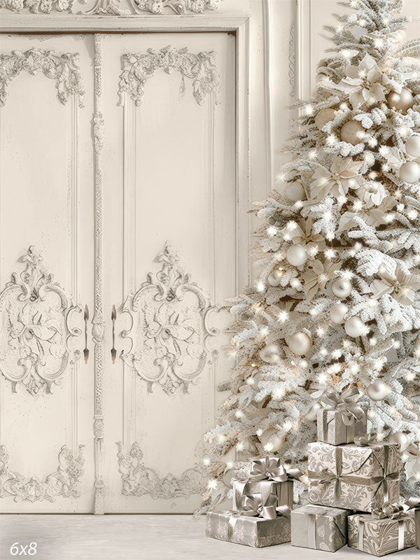 White Christmas tree with frosted branches, silver ornaments, and gifts set against ornate white paneled doors—ideal for elegant holiday portraits