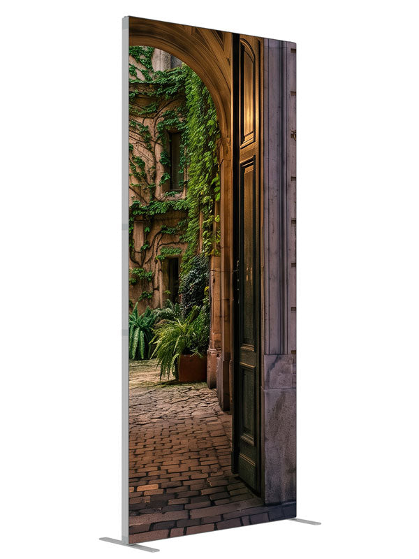 Stone archway opening onto an ivy-covered European courtyard with a glowing iron street lamp, 3ft photography backdrop panel for Denny StudioEdge silicone edge frame, angled view
