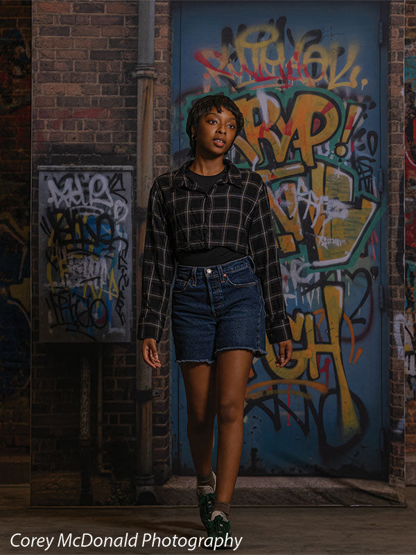 Keaton Graffiti Warehouse Door, photography backdrop panel for Denny StudioEdge silicone edge frame, shown with a senior girl mid-step in front of the graffiti warehouse door SECP-8864
