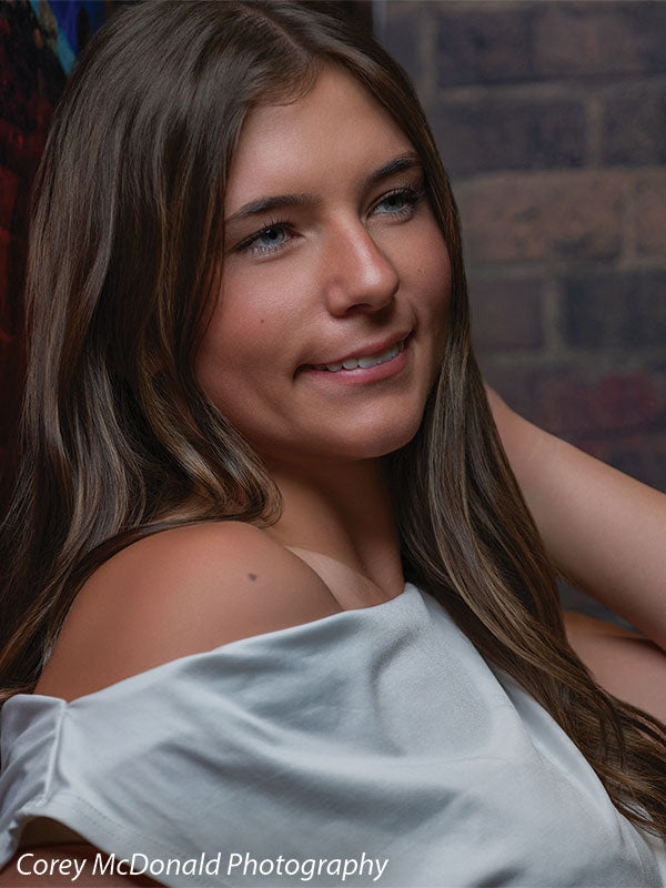Keaton Graffiti Warehouse Door, photography backdrop panel for Denny StudioEdge silicone edge frame, shown with a senior girl in an off-shoulder white top smiling in a close portrait SECP-8864