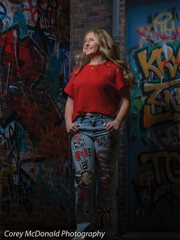 Keaton Graffiti Warehouse Door, photography backdrop panel for Denny StudioEdge silicone edge frame, shown with a senior girl in a red top standing with a hand on her hip SECP-8864
