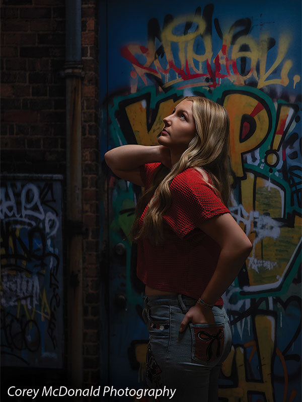 Keaton Graffiti Warehouse Door, photography backdrop panel for Denny StudioEdge silicone edge frame, shown with a senior girl in a red top in profile looking upward SECP-8864