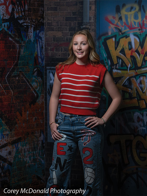 Keaton Graffiti Warehouse Door, photography backdrop panel for Denny StudioEdge silicone edge frame, shown with a senior girl in a red striped top and painted jeans with a hand on her hip SECP-8864
